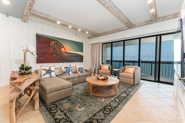 living room with beam ceiling and light tile patterned floors