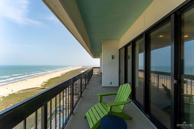 balcony featuring a water view and a view of the beach