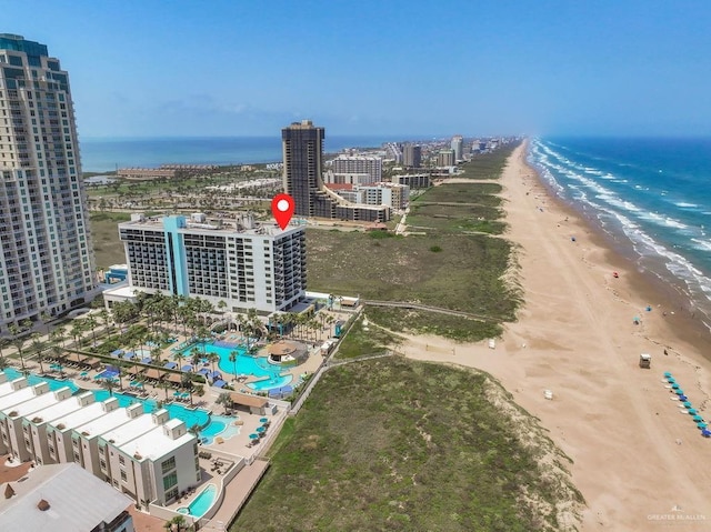 bird's eye view with a water view, a view of the beach, and a view of city