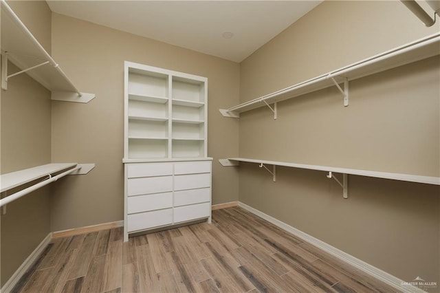 spacious closet with light hardwood / wood-style floors