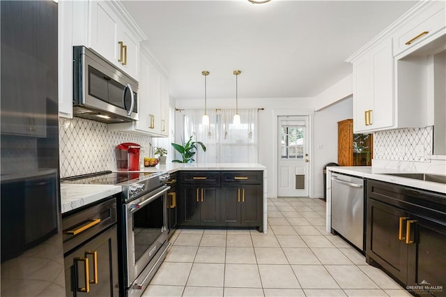 kitchen featuring decorative backsplash, decorative light fixtures, stainless steel appliances, and white cabinetry