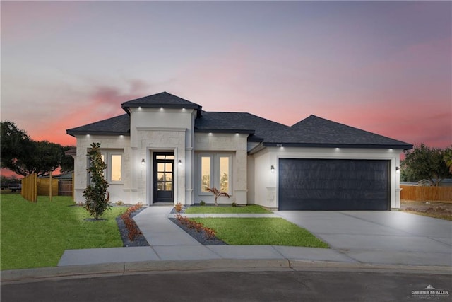 view of front of house featuring a yard and a garage