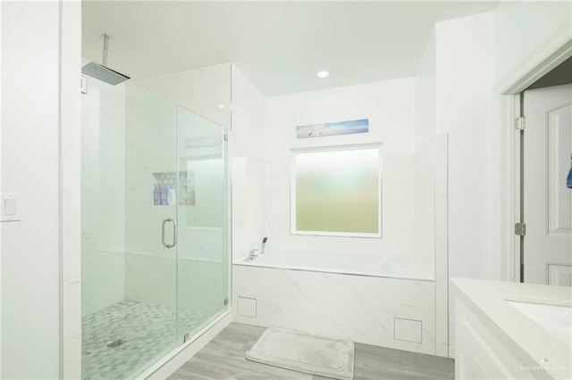 1102 Palm Blvd, Laguna Vista, TX 78578 - full bath featuring a garden tub, a marble finish shower, wood finished floors, and vanity