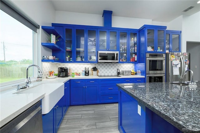 1102 Palm Blvd, Laguna Vista, TX 78578 - kitchen with stainless steel appliances, a sink, dark stone countertops, and tasteful backsplash