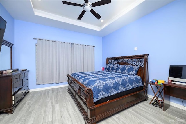 1102 Palm Blvd, Laguna Vista, TX 78578 - bedroom featuring wood finished floors, a tray ceiling, baseboards, and ceiling fan