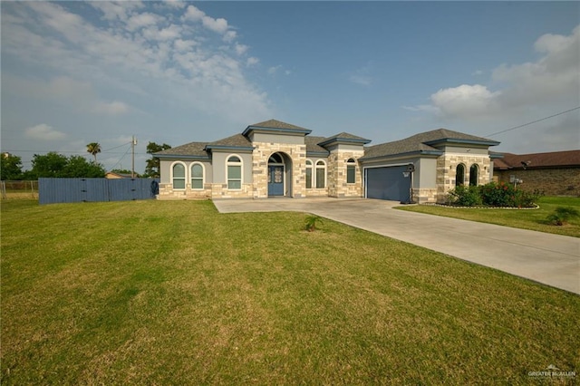 1102 Palm Blvd, Laguna Vista, TX 78578 - mediterranean / spanish-style home featuring stone siding, driveway, an attached garage, and stucco siding