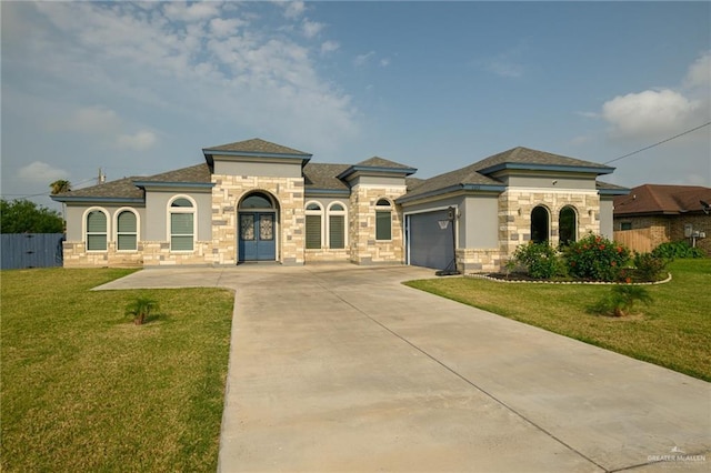 1102 Palm Blvd, Laguna Vista, TX 78578 - mediterranean / spanish home featuring an attached garage, stone siding, concrete driveway, stucco siding, and roof with shingles
