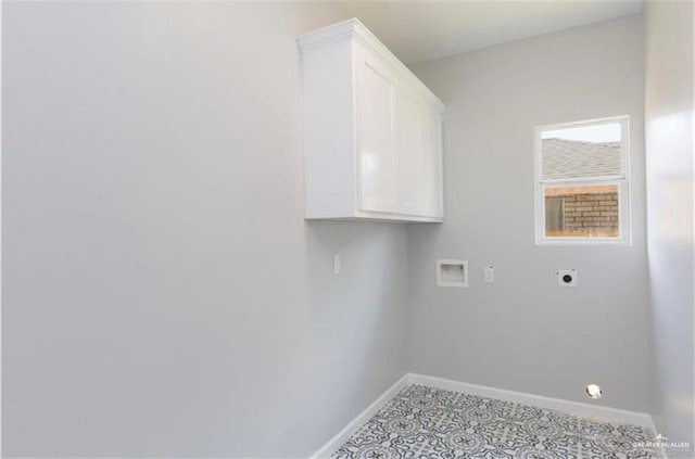 clothes washing area featuring baseboards, hookup for a washing machine, cabinet space, and hookup for an electric dryer