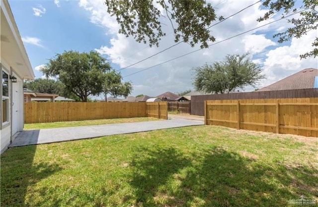 view of yard with a fenced backyard and a patio area