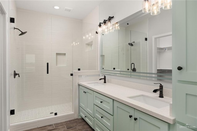 bathroom with a shower with door and vanity