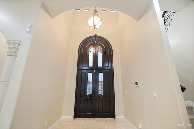 foyer with french doors and light tile patterned flooring