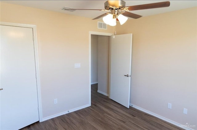 unfurnished bedroom featuring a ceiling fan, wood finished floors, visible vents, and baseboards