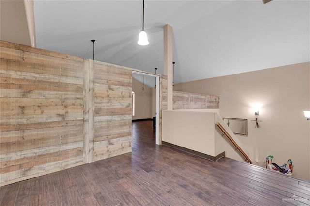 interior space featuring vaulted ceiling and dark hardwood / wood-style flooring