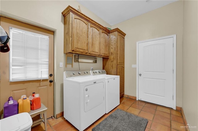 laundry area with cabinets, light tile patterned floors, and independent washer and dryer