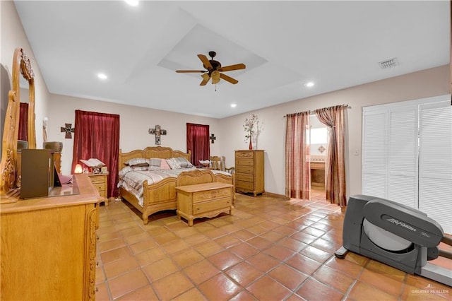 tiled bedroom with ensuite bathroom and ceiling fan