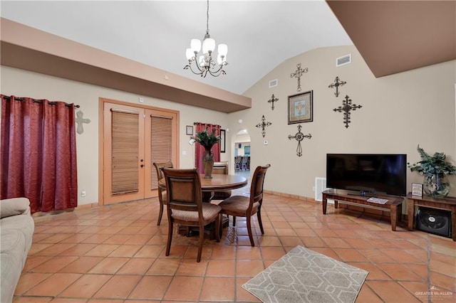 tiled dining area featuring lofted ceiling and an inviting chandelier