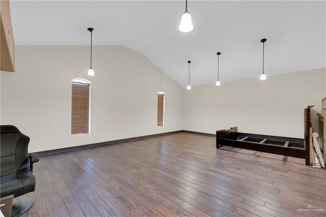 living room featuring high vaulted ceiling and hardwood / wood-style floors