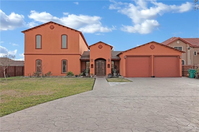 mediterranean / spanish-style home featuring a garage and a front yard