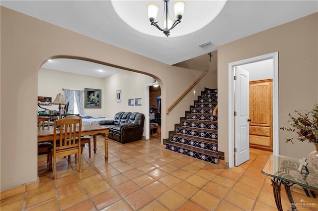 entryway featuring light tile patterned floors and an inviting chandelier