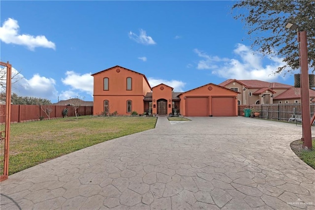 mediterranean / spanish-style home with a garage and a front yard