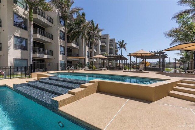 813 Travis St Unit 416, Mission, TX 78572 - pool featuring fence, a hot tub, and a patio