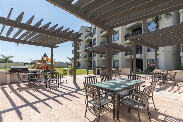 813 Travis St Unit 416, Mission, TX 78572 - view of patio featuring a pergola, outdoor dining area, and playground community