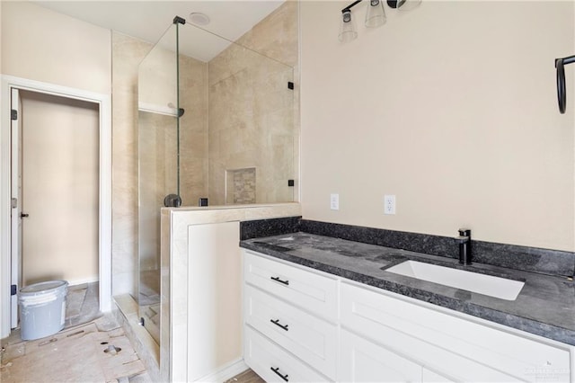 bathroom featuring vanity, toilet, and walk in shower