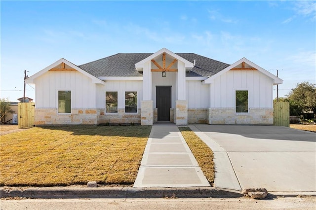 modern inspired farmhouse with a front lawn