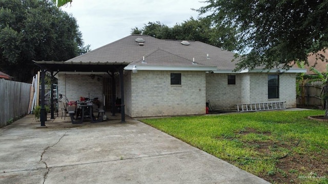 206 Justice Ln, San Juan, TX 78589 - back of house with a patio, concrete driveway, and brick siding