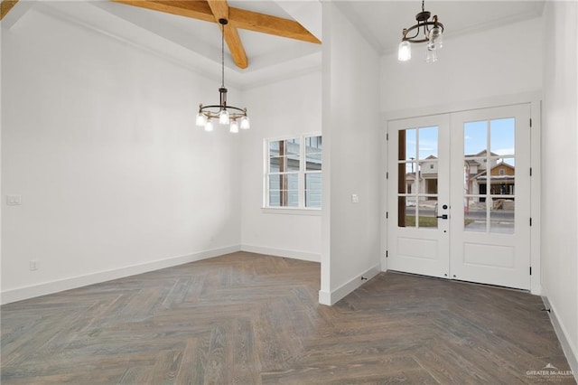 entrance foyer with dark parquet flooring, a chandelier, french doors, beam ceiling, and coffered ceiling