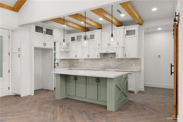 kitchen featuring decorative light fixtures, dark parquet flooring, and white cabinetry