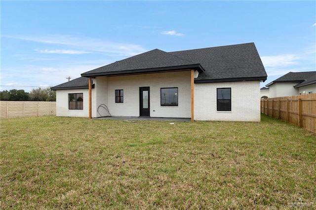 back of house with a lawn