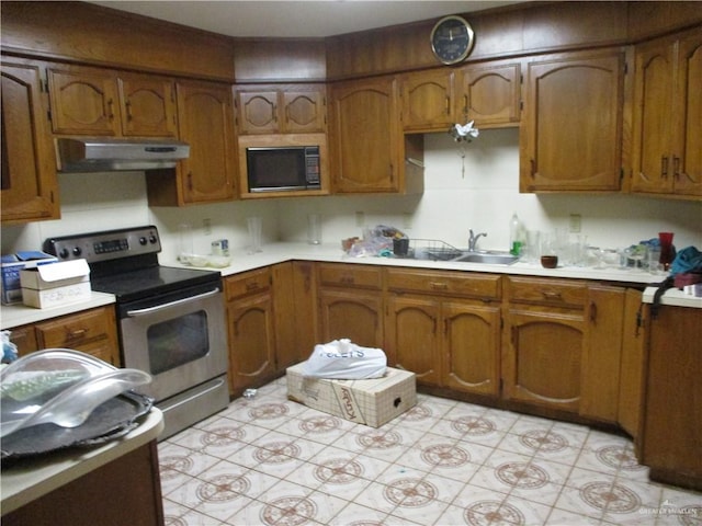 kitchen with sink, stainless steel electric range oven, and black microwave