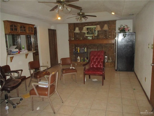 living area with ceiling fan and light tile patterned flooring