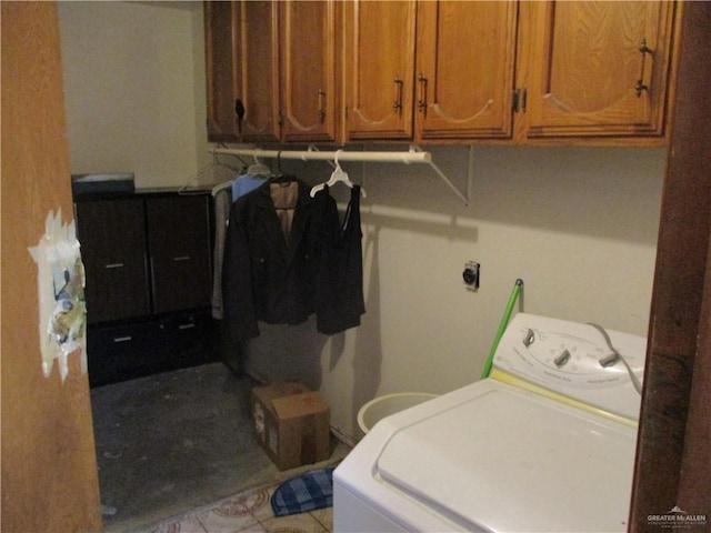 washroom featuring cabinets and washer / clothes dryer