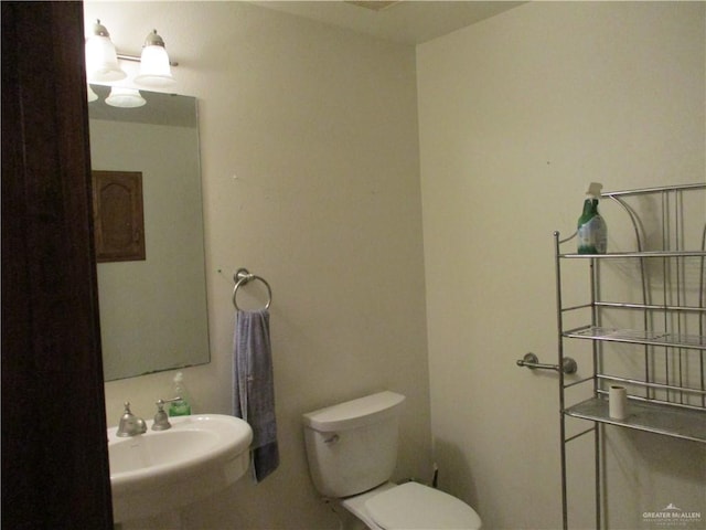 bathroom featuring sink and toilet