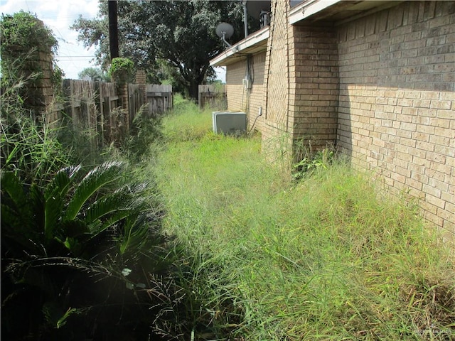 view of yard featuring central air condition unit