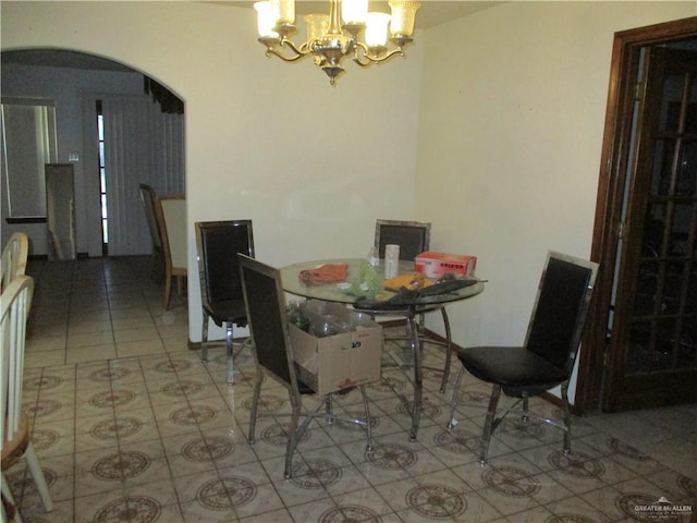 dining space with a notable chandelier and light tile patterned floors