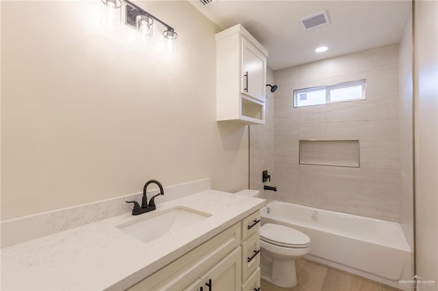 bathroom with bathtub / shower combination, visible vents, toilet, vanity, and wood finished floors