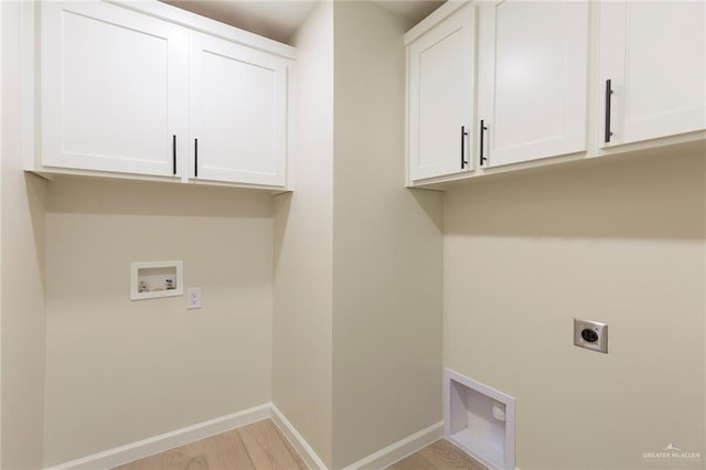 laundry room featuring hookup for an electric dryer, washer hookup, baseboards, light wood-style floors, and cabinet space