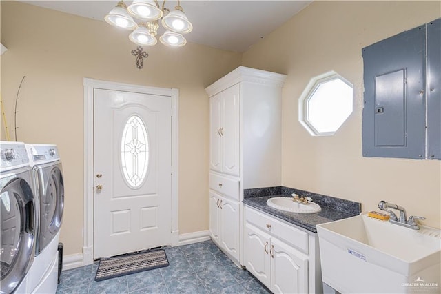 washroom with washer and clothes dryer, a notable chandelier, sink, and electric panel