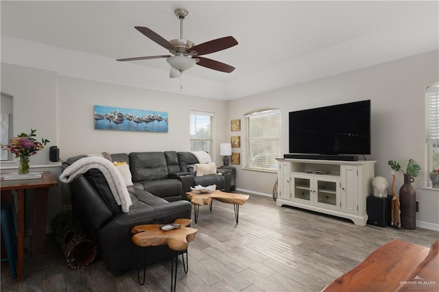 living room featuring ceiling fan and light hardwood / wood-style flooring