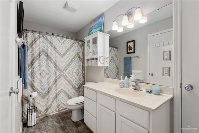 bathroom featuring hardwood / wood-style floors, vanity, and toilet