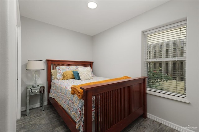 bedroom with dark hardwood / wood-style flooring