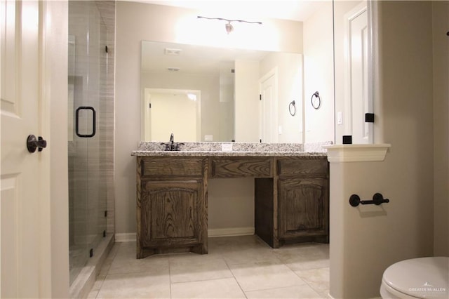 bathroom featuring tile patterned flooring, vanity, an enclosed shower, and toilet