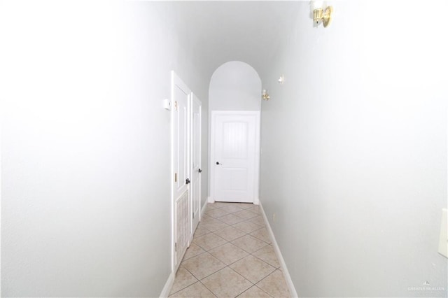 hall with light tile patterned floors