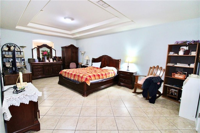 tiled bedroom with a raised ceiling