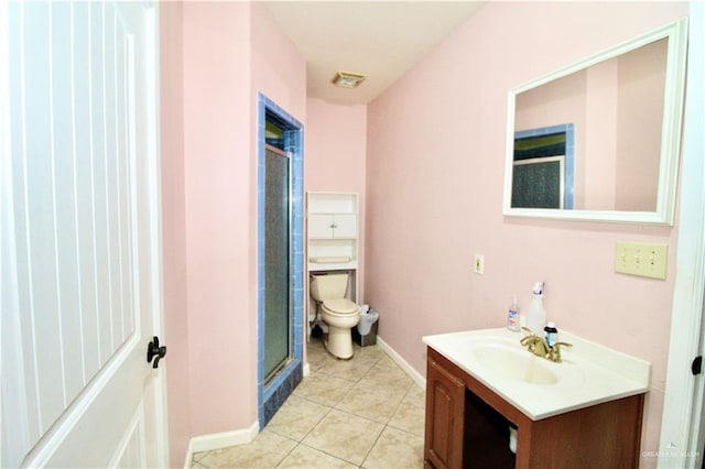 bathroom with walk in shower, tile patterned floors, vanity, and toilet