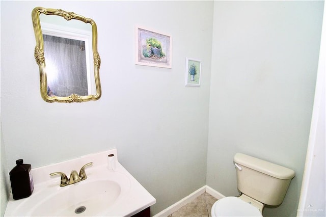 bathroom with tile patterned floors, vanity, and toilet