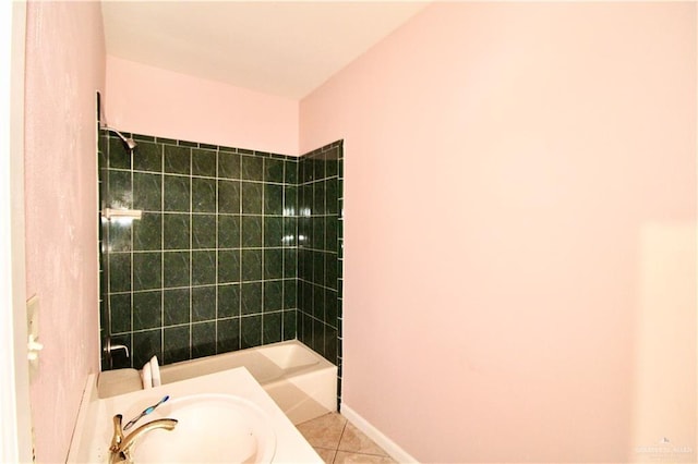 bathroom featuring tiled shower / bath, sink, and tile patterned flooring